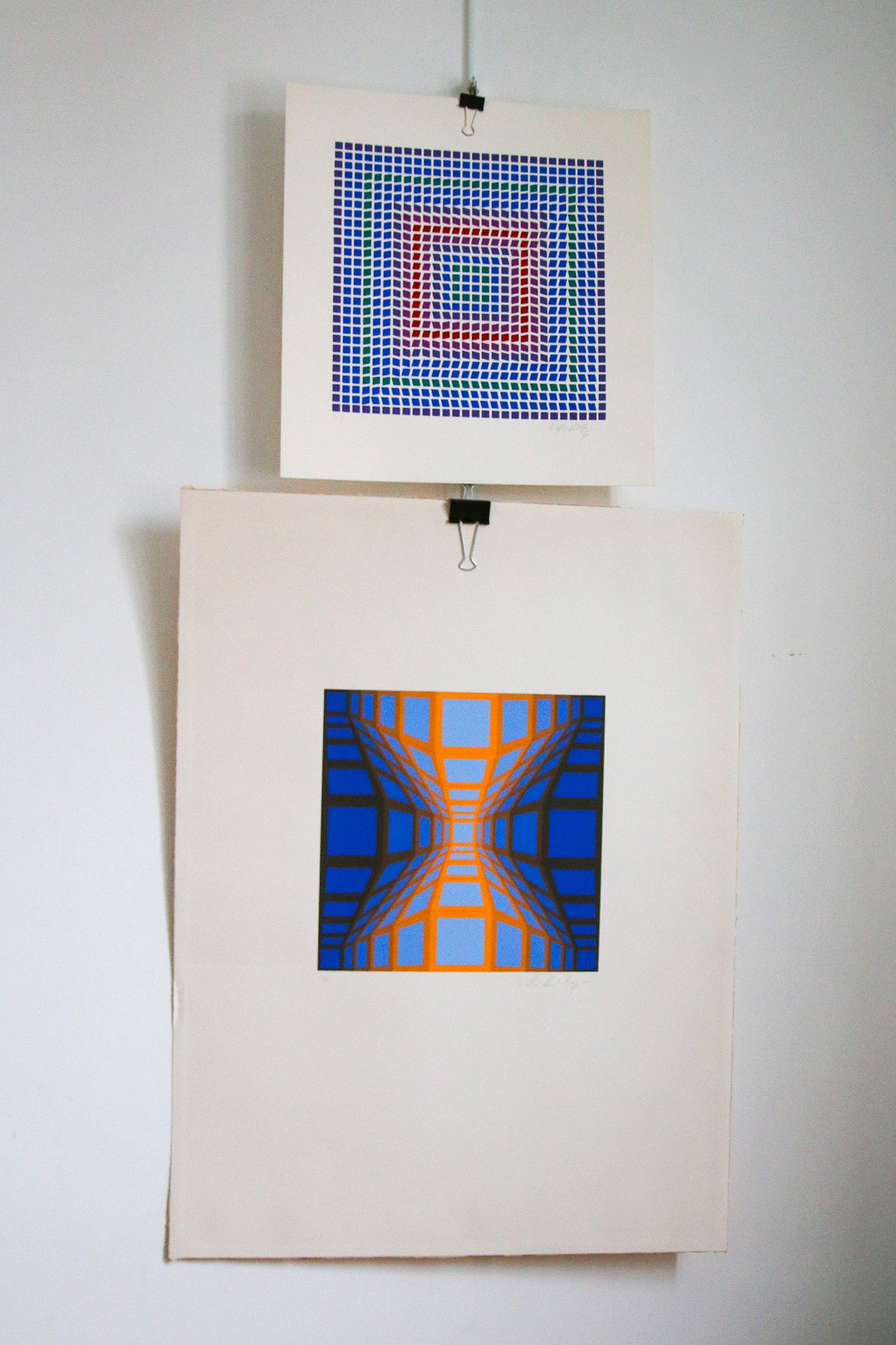 Association de deux sérigraphies de Victor Vasarely suspendues pour une décoration de salon mid-century.